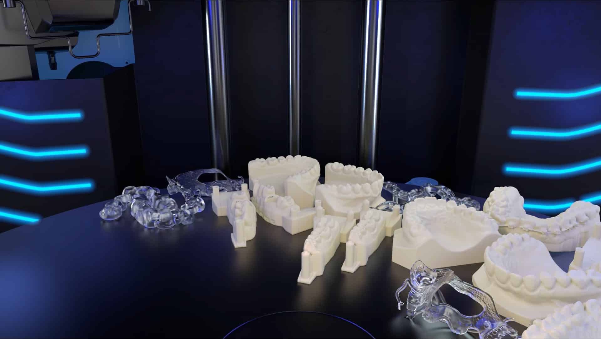 A variety of 3D-printed dental models displayed on a black table A variety of 3D-printed dental models displayed on a black table