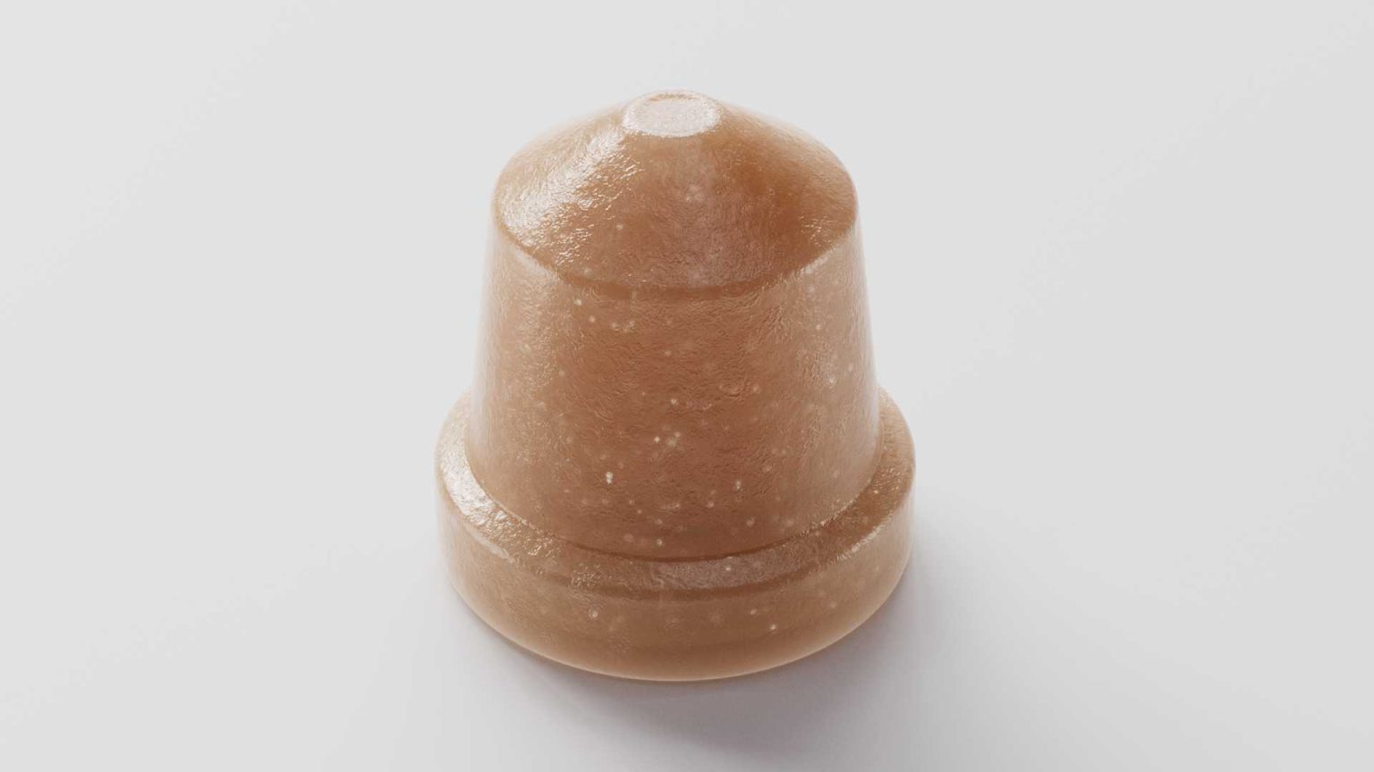 Close-up of a single iron gummy supplement on a white background