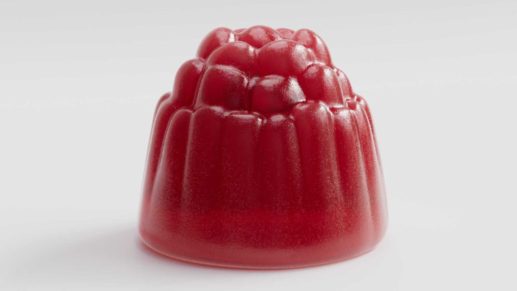 Close-up of a red gummy candy with a raspberry-like shape