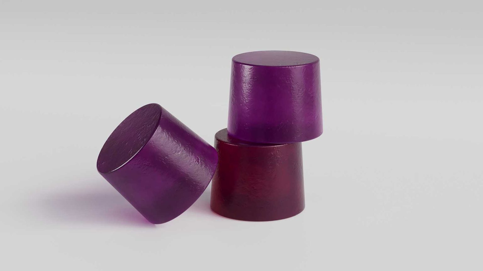 Three purple gummy supplements arranged on a clean surface